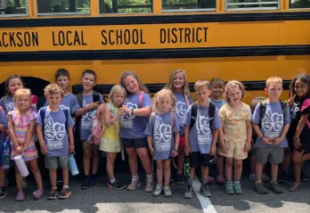 Kids in front of bus