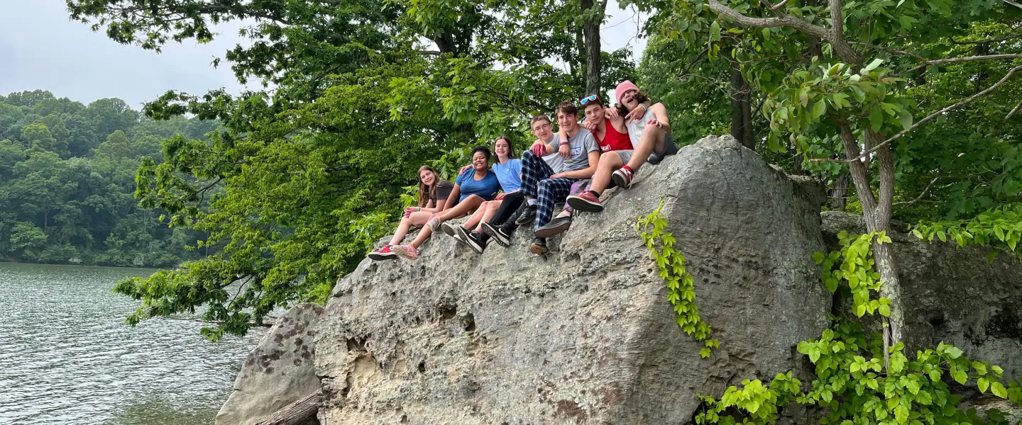 teens on lake rock