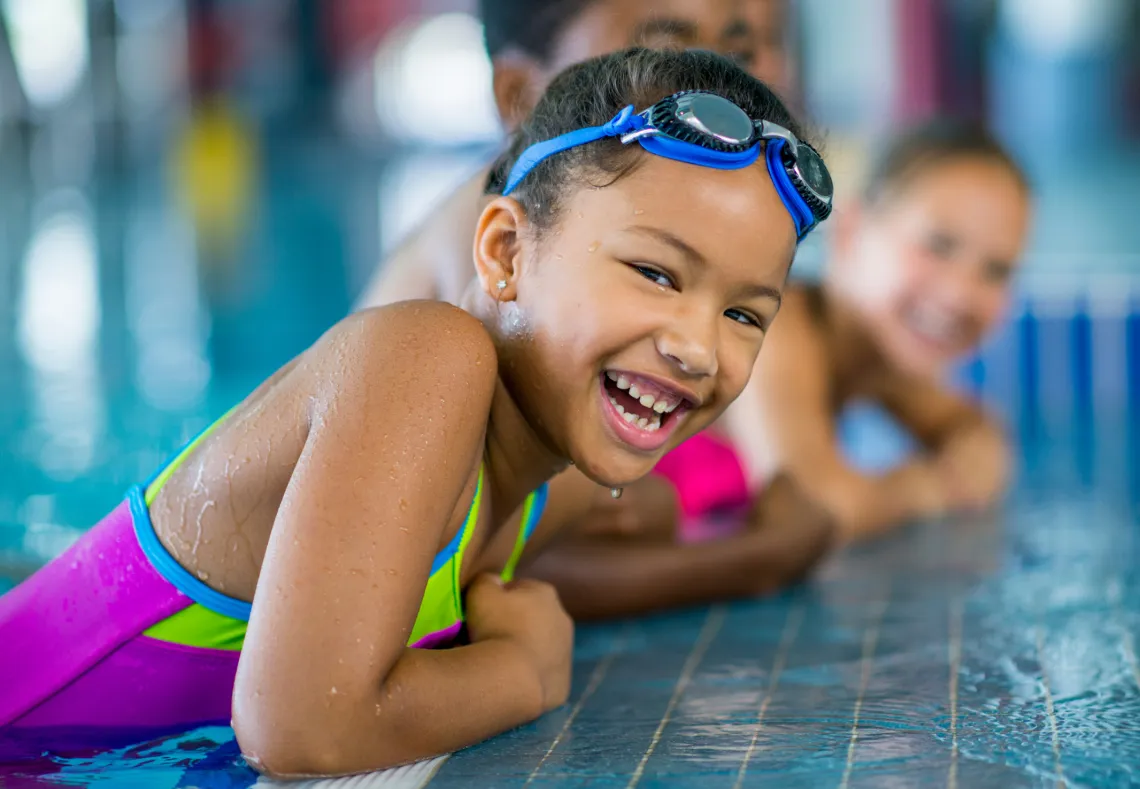 child laughing outside pool