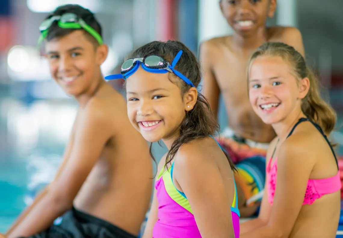 Kids sitting outside pool